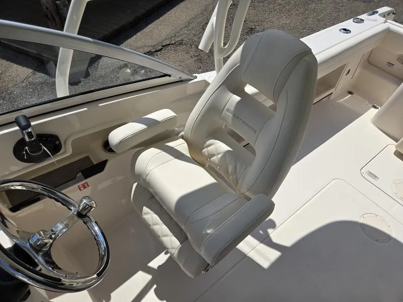 Slide: The Image of 2026 Grady-White Freedom 235 boat on trailer, parked on grass. - 11