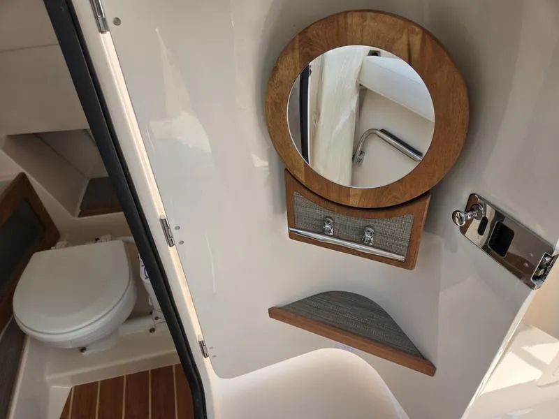 Slide: The Image of 2026 Grady-White Freedom 235 boat interior with speaker and storage compartment. - 16