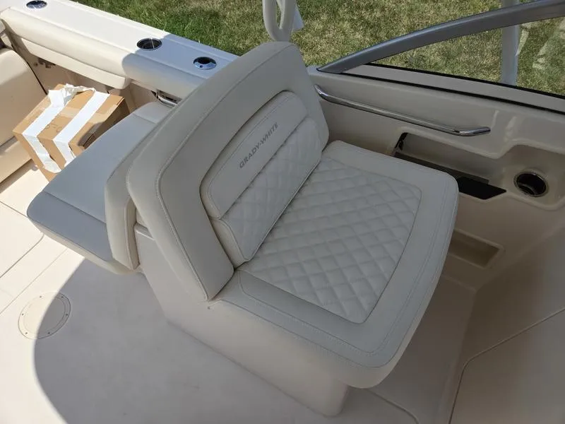 Slide: The Image of 2026 Grady-White Freedom 235 boat interior with cushioned seating and storage compartments. - 18
