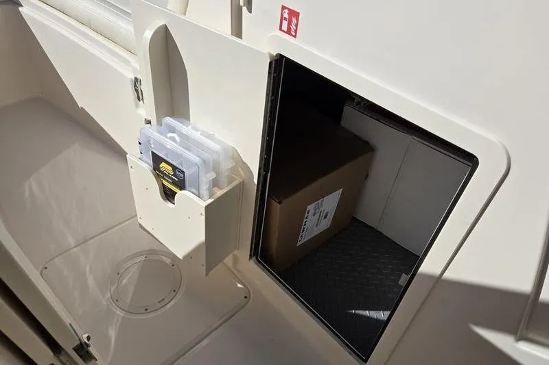 Slide: The Image of 2026 Grady-White Freedom 235 boat interior with luxurious captain's chair and controls. - 25