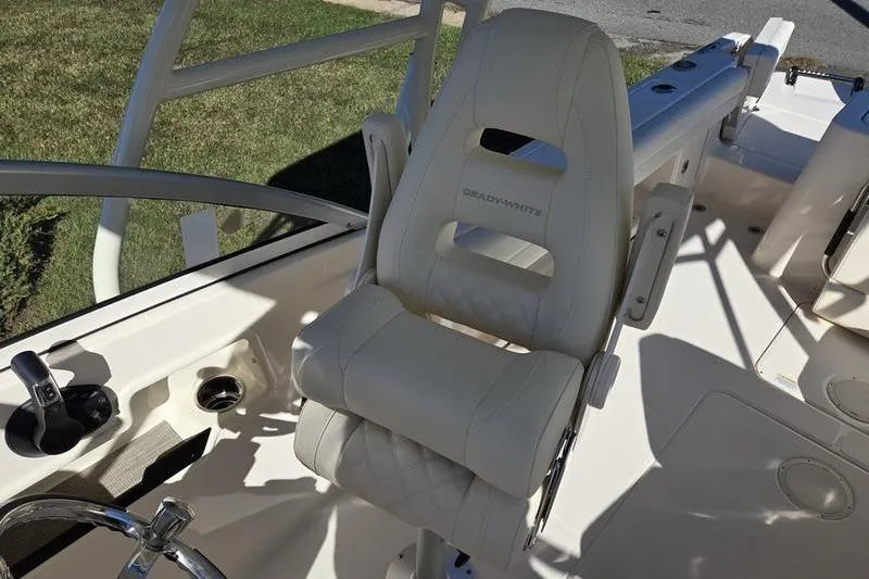 Slide: The Image of 2026 Grady-White Freedom 235 boat interior with white seating and open windshield. - 26