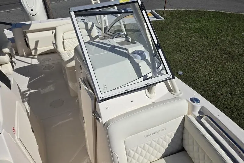Slide: The Image of 2026 Grady-White Freedom 235 boat interior with open storage compartment and cushioned seating. - 27