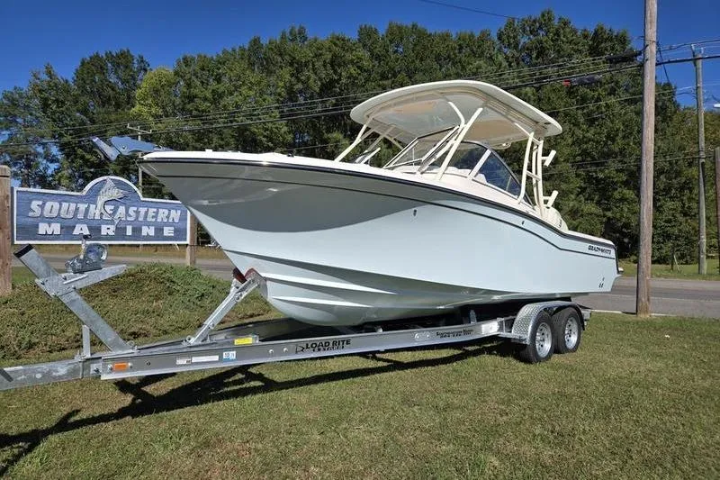 Slide: The Image of 2026 Grady-White Freedom 235 boat interior with cushioned seating and speakers. - 30