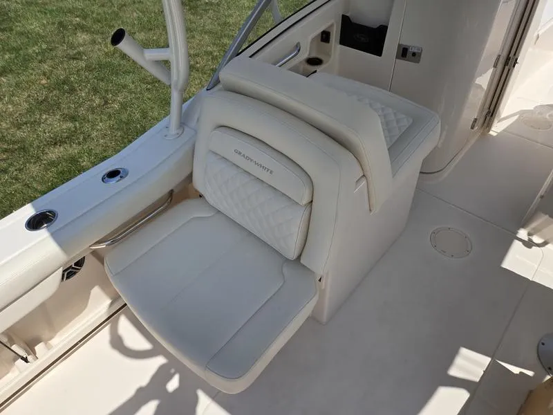 Slide: The Image of 2026 Grady-White Freedom 235 boat interior, featuring storage compartment and control panel. - 6