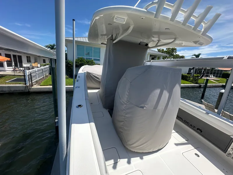Slide: The Image of 2024 World Cat 280ccx boat docked, featuring covered seating and sleek design. - 11