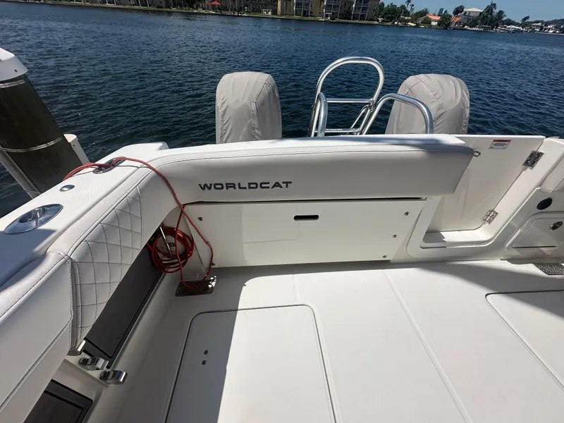 Slide: The Image of 2024 World Cat 280ccx boat interior with white seating and water view. - 13