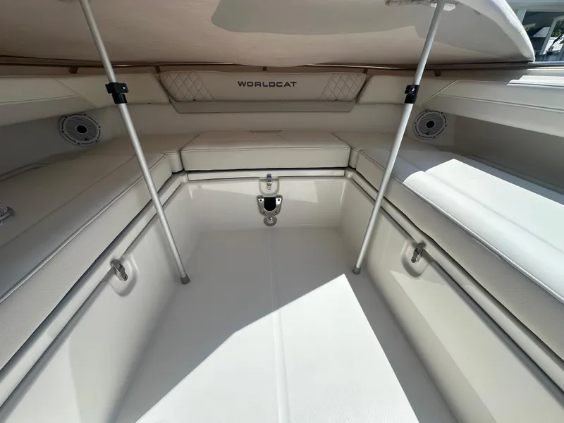 Slide: The Image of 2024 World Cat 280ccx boat interior with cushioned seating and storage compartments. - 16