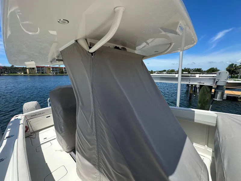 Slide: The Image of 2024 World Cat 280ccx boat with covered console, docked by the water. - 20