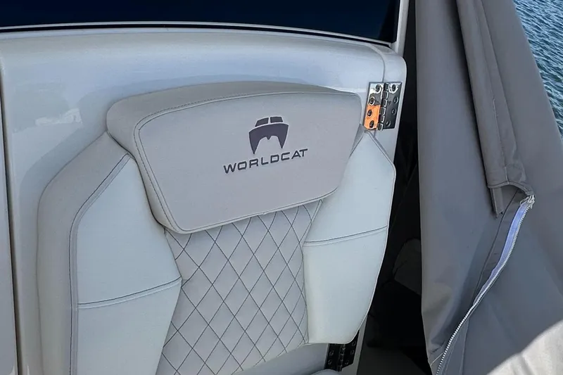 Slide: The Image of 2024 World Cat 280ccx boat seat with logo, featuring diamond-patterned upholstery. - 26