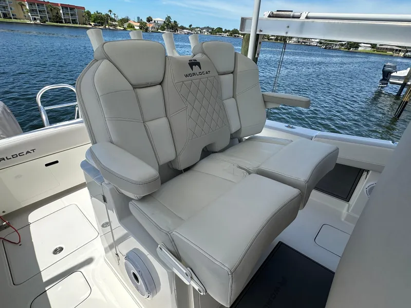 Slide: The Image of 2024 World Cat 280ccx boat interior with luxurious seating, overlooking a scenic waterfront. - 29