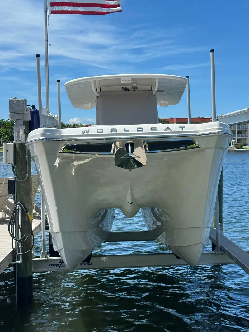 Slide: The Image of 2024 World Cat 280ccx catamaran docked, viewed from the front, with American flag above. - 3