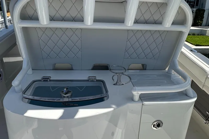 Slide: The Image of 2024 World Cat 280ccx boat interior with rod holders and storage compartment. - 37
