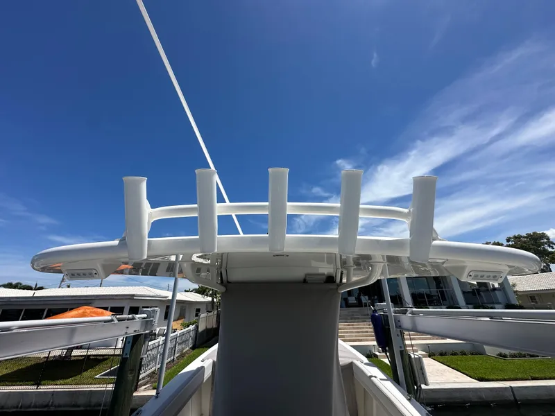 Slide: The Image of 2024 World Cat 280ccx boat with rod holders under a clear blue sky. - 38