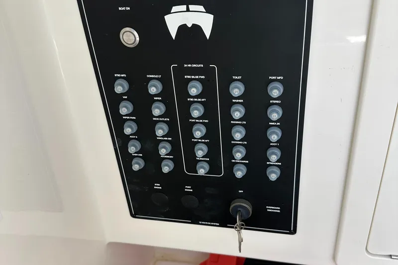 Slide: The Image of 2024 World Cat 280ccx control panel with labeled switches and key ignition. - 44