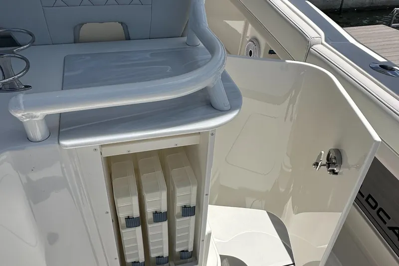 Slide: The Image of 2024 World Cat 280ccx boat interior with storage compartments and seating area. - 46