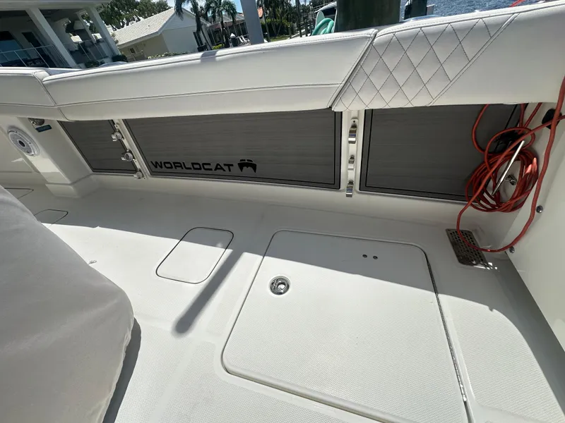 Slide: The Image of 2024 World Cat 280ccx boat interior with white seating and storage compartments. - 9