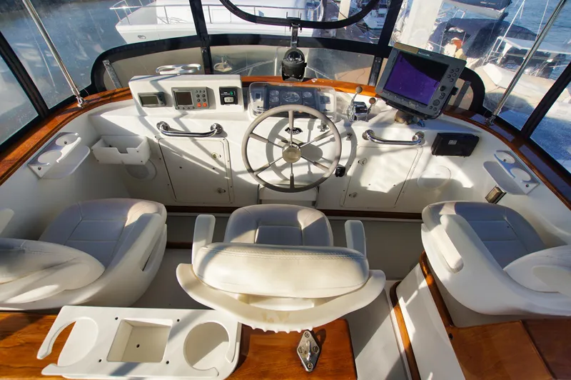 Slide: The Image of Helm of 2001 Monk 36 boat with steering wheel, navigation equipment, and seating. - 12