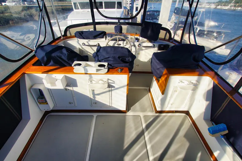 Slide: The Image of Helm of 2001 Monk 36 (Hull #215) yacht with covered seats and steering wheel. - 13