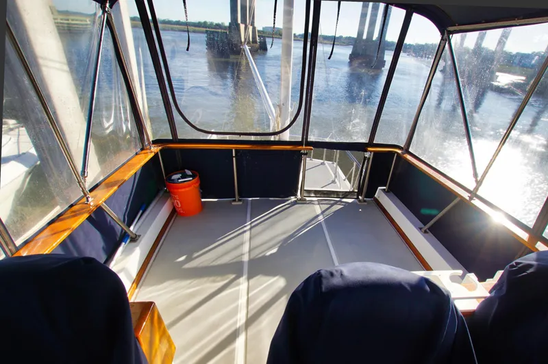 Slide: The Image of Enclosed deck area of 2001 Monk 36 boat with river view. - 14