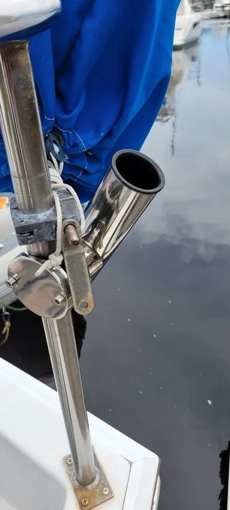 Slide: The Image of Stainless steel rod holder on a 2001 Monk 36 boat, docked by the water. - 20
