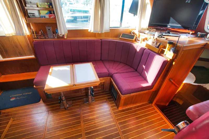 Slide: The Image of Luxurious 2001 Monk 36 yacht interior with plush seating and wooden accents. - 27