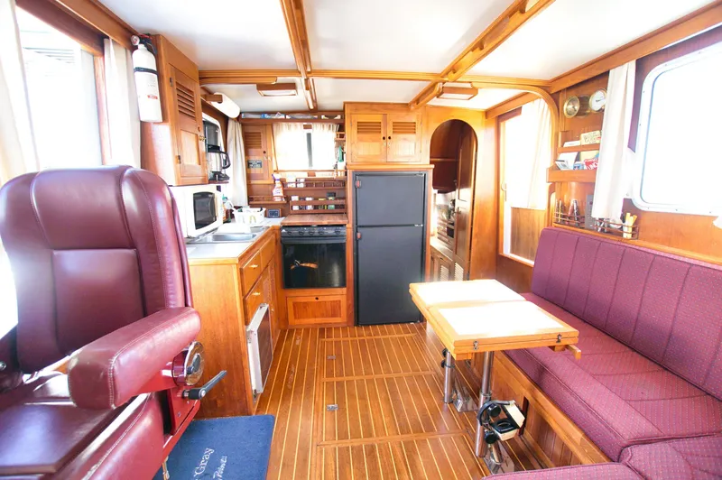 Slide: The Image of Interior of 2001 Monk 36 boat with kitchen, seating, and wooden finishes. - 28