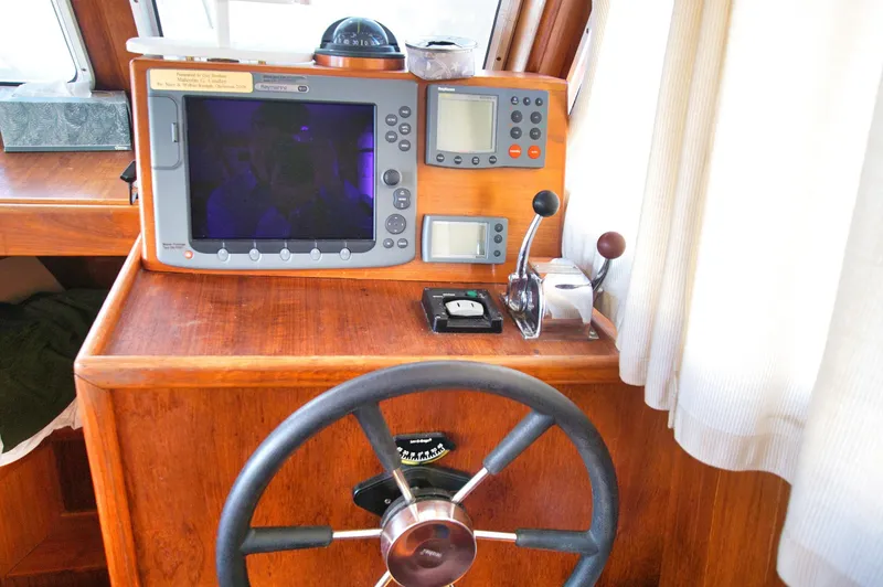 Slide: The Image of Helm station of 2001 Monk 36 boat with navigation equipment and steering wheel. - 30
