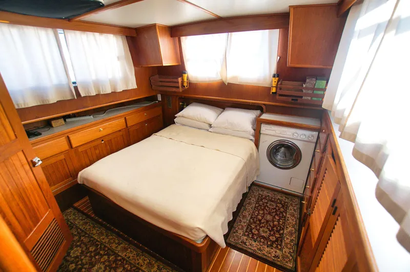 Slide: The Image of Cozy cabin interior of 2001 Monk 36 yacht with bed and washing machine. - 32