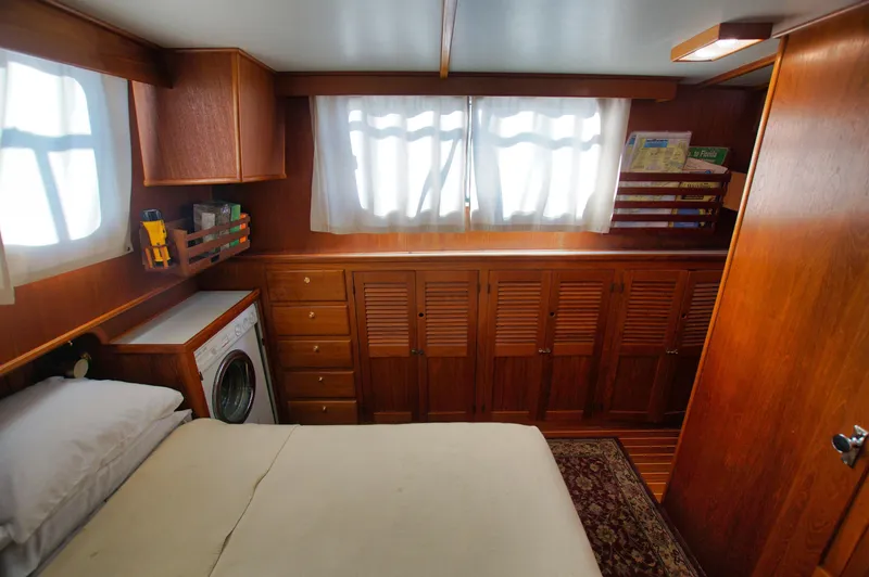 Slide: The Image of Cozy cabin interior of 2001 Monk 36 boat with wood paneling and built-in storage. - 33