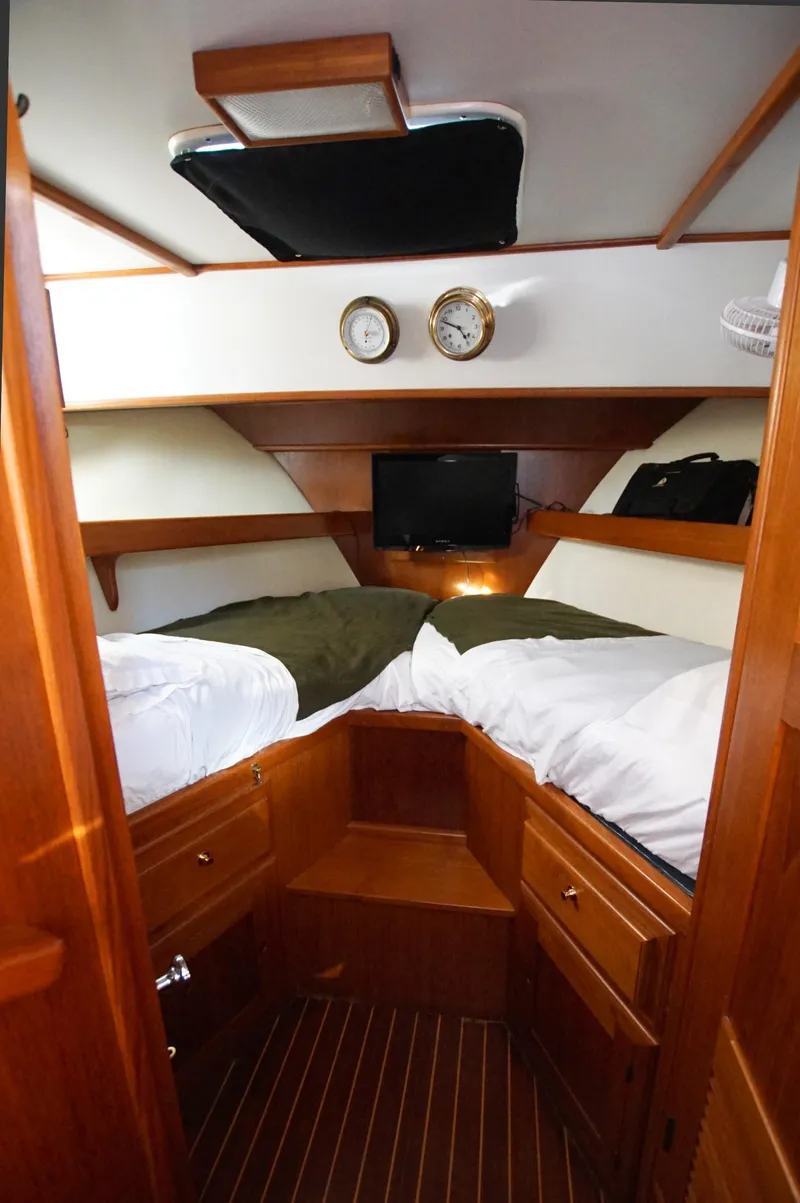 Slide: The Image of Cozy cabin interior of 2001 Monk 36 boat with twin beds and wooden finish. - 35
