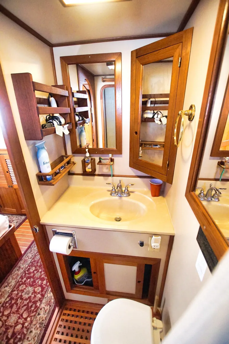 Slide: The Image of Bathroom interior of 2001 Monk 36 boat, featuring wooden cabinetry and sink. - 37
