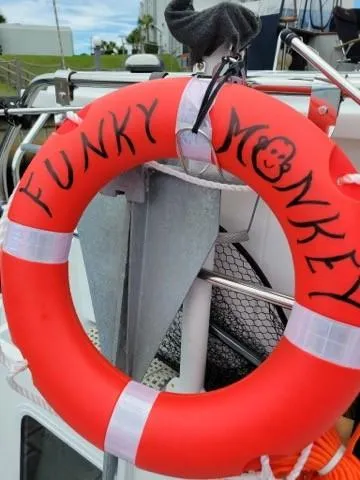 Slide: The Image of Red life ring labeled "Funky Monkey" on Monk 36 boat, 2001 model. - 43