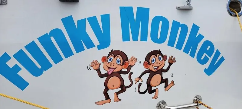 Slide: The Image of "Funky Monkey" boat graphic with playful cartoon monkeys, Monk 36 (Hull #215), 2001 model. - 44