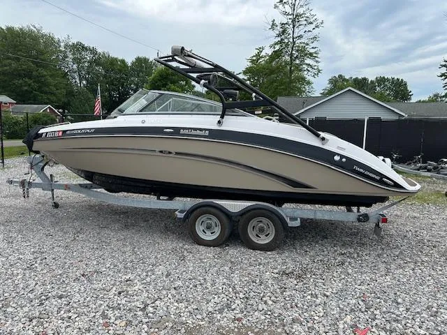 Slide: The Image of 2013 Yamaha Boats 242 Limited S on trailer, parked outdoors on gravel. - 1