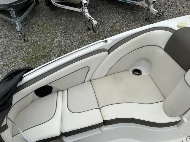 Slide: The Image of 2013 Yamaha Boats 242 Limited S interior seating with white and gray upholstery. - 10