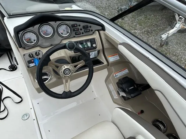 Slide: The Image of 2013 Yamaha Boats 242 Limited S dashboard with steering wheel and control panel. - 5