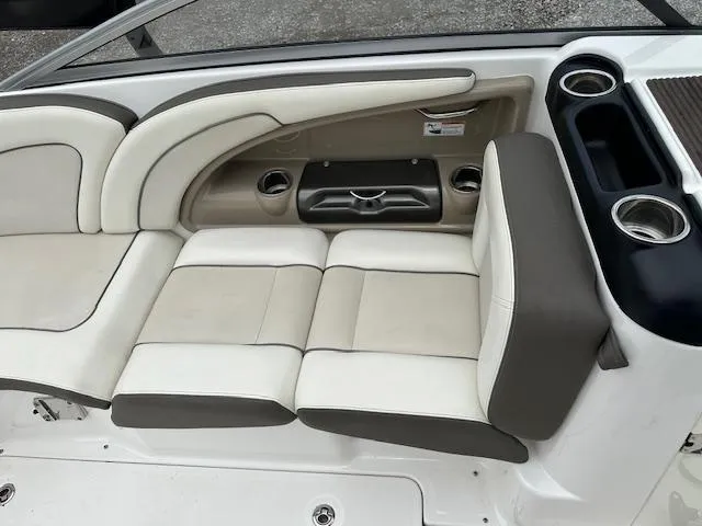 Slide: The Image of 2013 Yamaha Boats 242 Limited S interior seating with cup holders and storage. - 6
