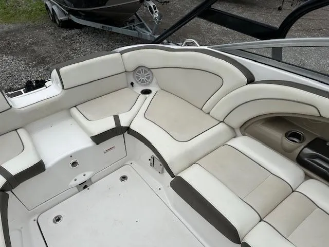 Slide: The Image of 2013 Yamaha Boats 242 Limited S interior with white and beige seating. - 7