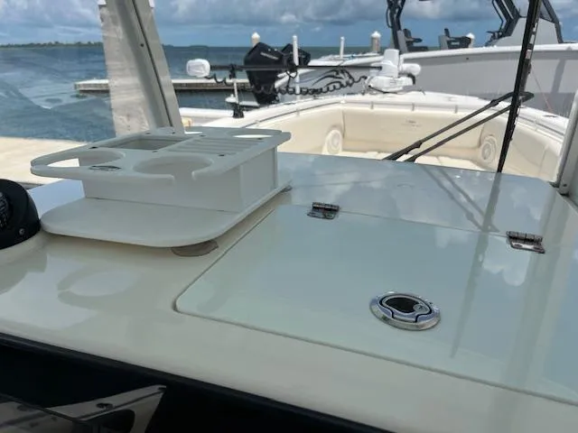 Slide: The Image of 2019 Cobia 320 Center Console boat interior with ocean view in the background. - 10