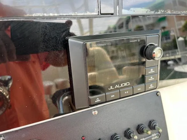 Slide: The Image of JL Audio system on 2019 Cobia 320 Center Console boat dashboard. - 13
