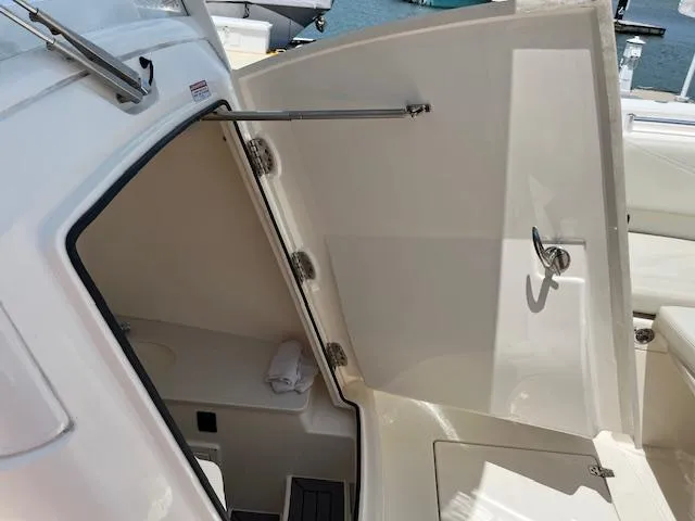 Slide: The Image of 2019 Cobia 320 Center Console boat interior with open storage compartment. - 15