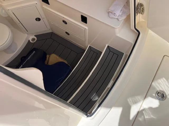 Slide: The Image of 2019 Cobia 320 Center Console interior with steps, storage, and marine accessories. - 16