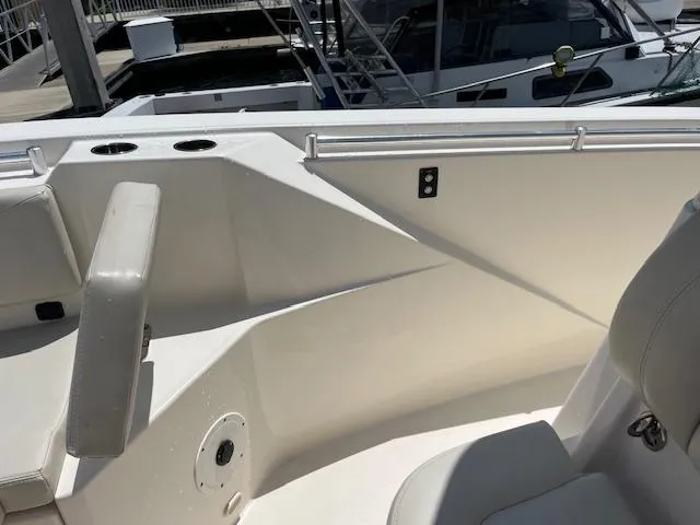 Slide: The Image of 2019 Cobia 320 Center Console boat interior with seating and cup holders. - 20
