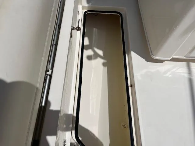 Slide: The Image of Open storage compartment on a 2019 Cobia 320 Center Console boat. - 22