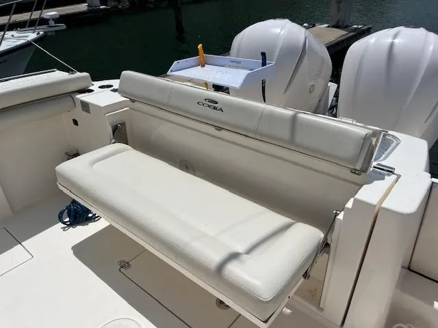 Slide: The Image of 2019 Cobia 320 Center Console boat with white seating and dual engines. - 25