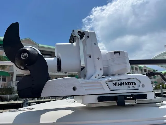 Slide: The Image of Minn Kota Instinct motor on 2019 Cobia 320 Center Console boat under blue sky. - 30
