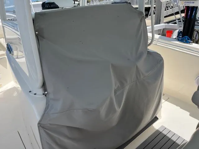 Slide: The Image of 2019 Cobia 320 Center Console helm covered with a protective gray cover. - 5