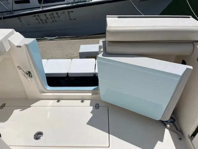 Slide: The Image of 2019 Cobia 320 Center Console boat interior with seating and storage compartments. - 6