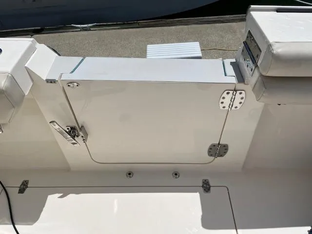 Slide: The Image of 2019 Cobia 320 Center Console boat deck with closed hatch and seating. - 7