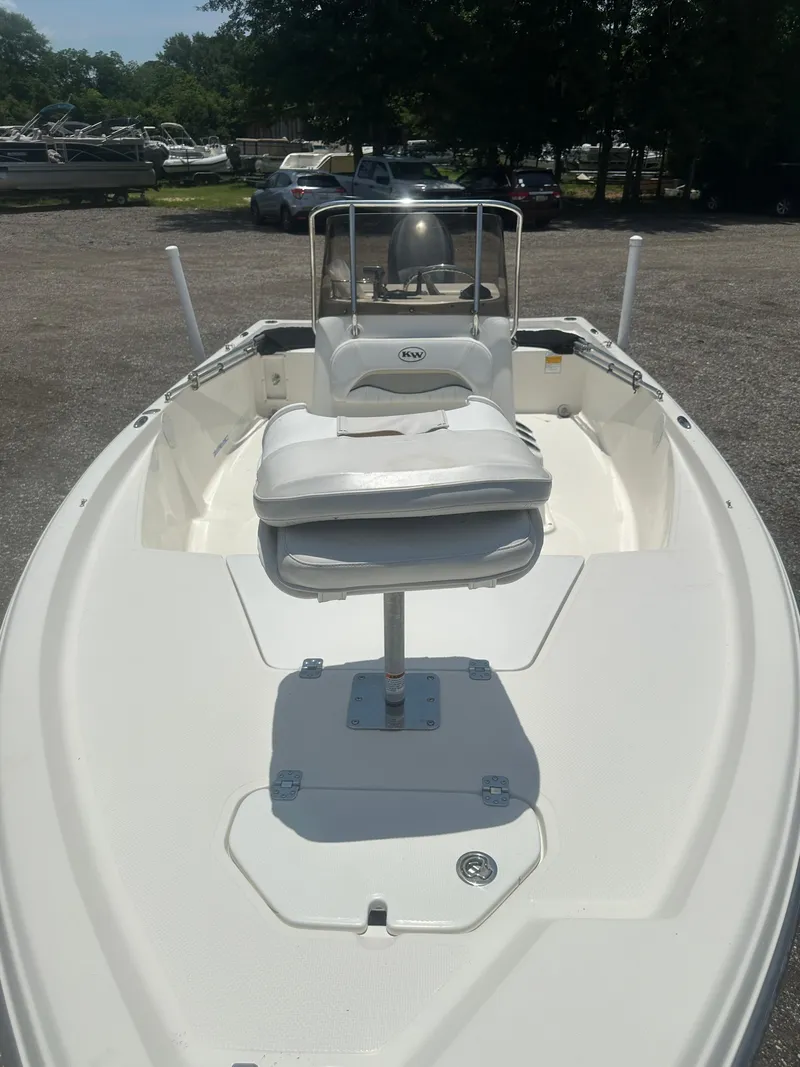 Slide: The Image of 2008 Key West 186 Bay Reef boat with white seating, parked outdoors. - 11